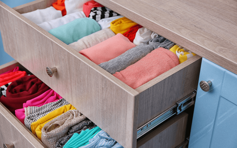 Clothes neatly folded in a fabric drawer organizer